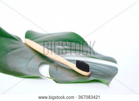 The Concept Of Zero Waste. Bamboo Toothbrush On A Manstera Leaf