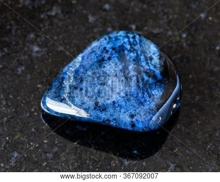 Closeup Of Sample Of Natural Mineral From Geological Collection - Rolled Dumortierite Rock On Black 