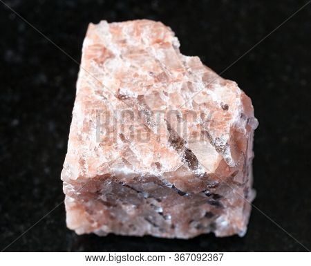 Closeup Of Sample Of Natural Mineral From Geological Collection - Rough Granite Pegmatite Rock On Bl