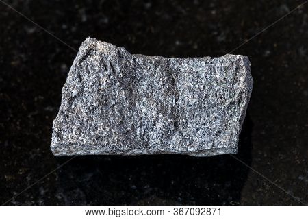 Closeup Of Sample Of Natural Mineral From Geological Collection - Unpolished Chromite Rock On Black 
