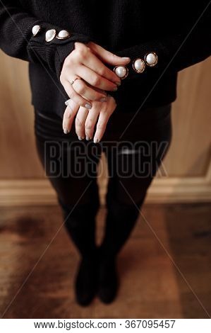 Cropped Photo Of A Stylish Woman In Black Outfit With Pearls Details. Ashion Concept