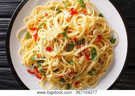 Italian Food Spaghetti Aglio E Olio With Fried Garlic, Parsley And Hot Pepper Close-up In A Plate. H