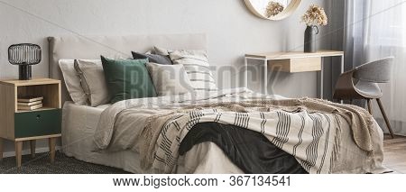 Cozy Pillows On Comfortable Big King Size Bed In Bright Bedroom Interior In Elegant Apartment