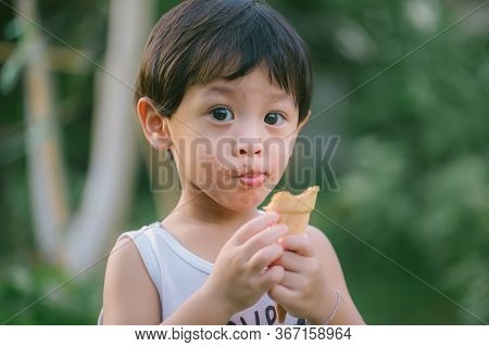 Asia Boy He Mouth Aftertaste From Eating Chocolate Ice Cream  Or Chocolate Dessert. A Sweet-toothed 