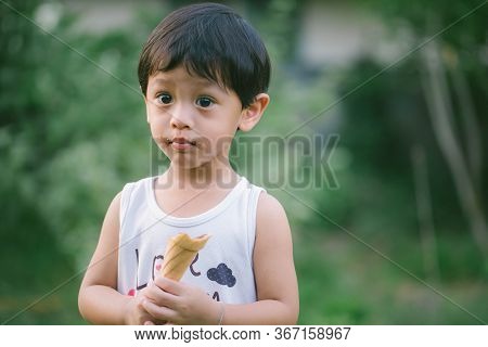Asia Boy He Mouth Aftertaste From Eating Chocolate Ice Cream  Or Chocolate Dessert. A Sweet-toothed 