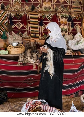 Mitzpe Ramon, Israel, September 28, 2019 : A Bedouin Woman Shows How To Properly Make A Thread Of Wo