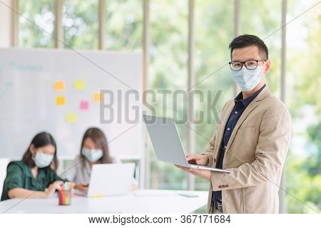 Business Employees Wearing Mask During Work In Office To Keep Hygiene Follow Company Policy.preventi