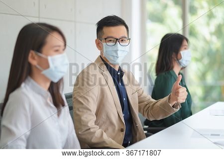 Business Employees Wearing Mask During Work In Office To Keep Hygiene Follow Company Policy.preventi