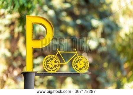 Designation Of Parking For Bicycles. Big Yellow Letter P On A Pillar.
