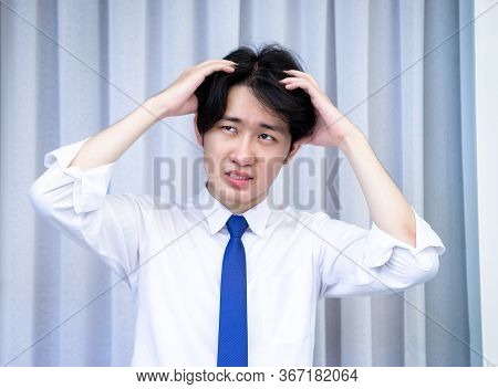 Asian Business Man Dringking Coffee Wearing Suit, Enjoying Watching Educational Webinar On Laptop Or