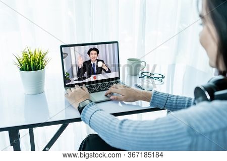 Asian Business Woman Dringking Coffee Wearing Headphone, Enjoying Watching Educational Webinar On La