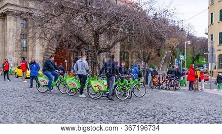 Budapest, Hungary - 03 16 2019 : Young Tourists Use The Mols Bubi Bikes At The Buda Castle Tunnel.