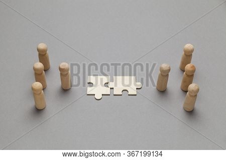 Wooden Figures With Pazzles On Grey Background. Agreement Between Business Mans, Cooperation And Dea