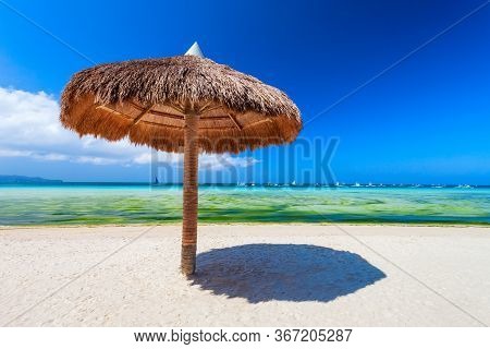 Tropical Vacation At White Sand Beach With Umbrella In Boracay Island In Philiphines