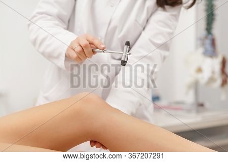 Neurologist Testing Knee Reflex Using Reflex Hammer. Neurological Physical Examination. Orthopedist 