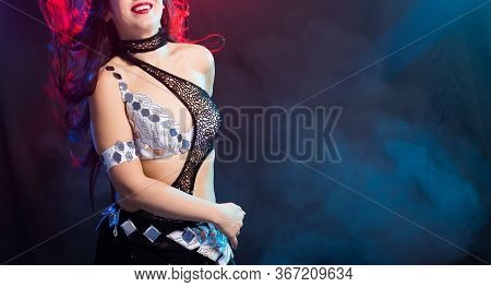 Close-up Of Girl Dancing Belly Dance, Fusion Or Tribal. A Woman In A Beautiful Costume Demonstrates 