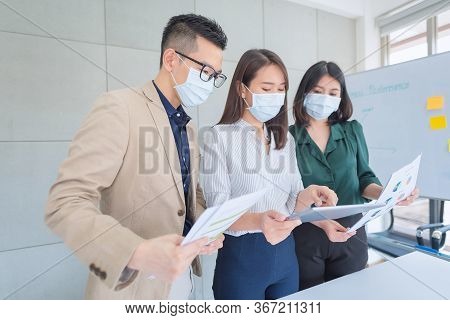 Business Employees Wearing Mask During Work In Office To Keep Hygiene Follow Company Policy.preventi