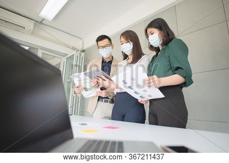 Business Employees Wearing Mask During Work In Office To Keep Hygiene Follow Company Policy.preventi