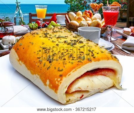 Breakfast Brazilian snack, wrapped in ham and mozzarella, joelho
