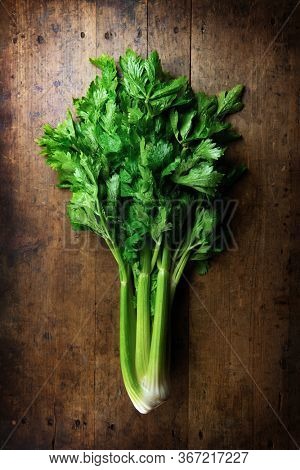 Nice shaped celery with leaves still intact on an old grungy kitchen table.
Celery shot from above.