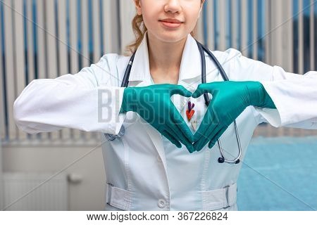 The Doctor Hands Shows The Heart, A Symbol Of Health. Copy Space, Modern Medicine, Hypocrate Oath