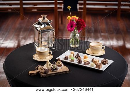 Mix Of Chocolates On A Table With Black Background, Confectioners Assortment Of Bon Bon Candies