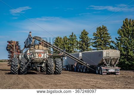 Swift Current, Sk/canada- May 15, 2020: Farmers Loading Seed And Fertilizer From The Super B Into Th