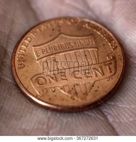 American Us Coin 1 Cent Penny Lies On A Dirty Palm Close Up. An Impressive, Dramatic Square Shot Wit