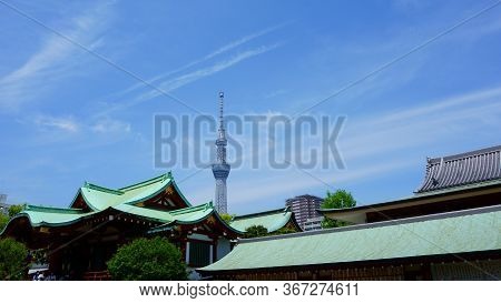Tokyo / Japan - May 05, 2019: Main Building, Kameido Tenjin Shrine. Towers Behind The Shrine, Adding