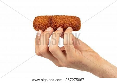 Brown Crusty Dutch Kroket Held By An Adult Man, Isolated On A White Background
