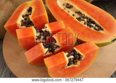 Papaya, Sliced. Delicious Fresh Exotic Healthy Fruits. Close Up Image Of Papaya On Wooden Table
