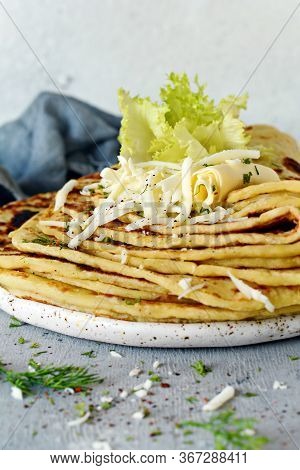 Norwegian Potato Pancakes Lefse On A Light Background With Cheese And Greens. Traditional Scandinavi