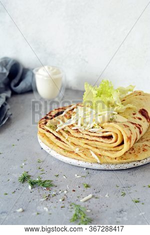 Norwegian Potato Pancakes Lefse On A Light Background With Cheese And Greens. Traditional Scandinavi
