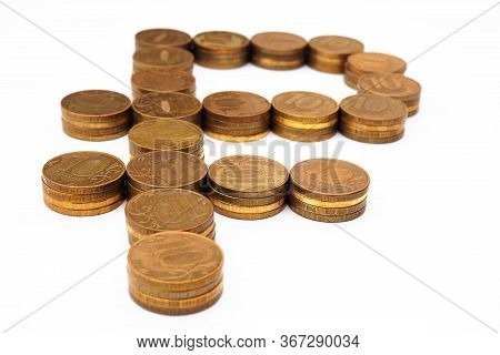 The Sign Of The Russian Ruble, Laid Out In Stacks Of Coins Of 10 Rubles. The Background Is White, No