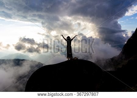 A Woman Standing With Arms On A Rock With A Cloudy Background Similar To A Tornado : Mulayit Taung,m