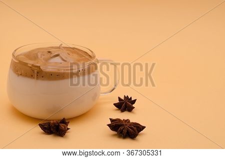 Dalgon Coffee In A Glass Small Cup On A Beige Background. Nearby Are Anise Flowers. Copy Space, Hori