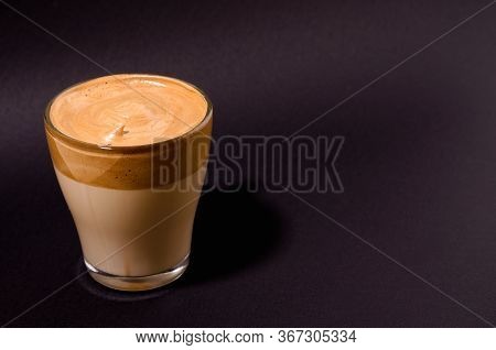 Dalgon Coffee In A Transparent Glass On A Dark Background. Milk And Whipped Coffee Foam With Sugar O