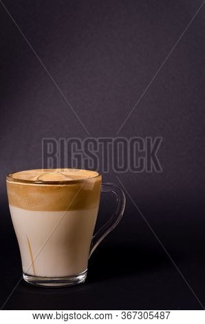 Dalgon Iced Coffee In A Transparent Glass On A Dark Background. Korean And Indian Whipped Coffee, Co