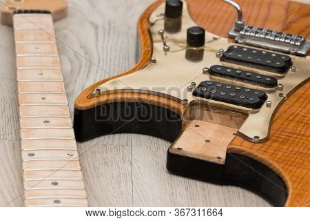Electric Guitar Repair. Close-up Of Neck Removed From Body For Refinishing. Preparation For Fret Dre