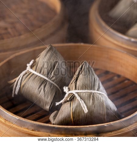 Rice Dumpling, Zongzi - Chinese Rice Dumpling Zongzi On Black Brick Background Slate Table, Concept