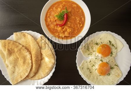 Famous Traditional Arabic Breakfast - Peeled Fava Beans With Chili Pepper In White Bowl, Pita Bread 