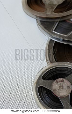 Several Plastic Bobbins Close-up. Old Bobbins With Audio Recordings On A Light Background. Real Bobb