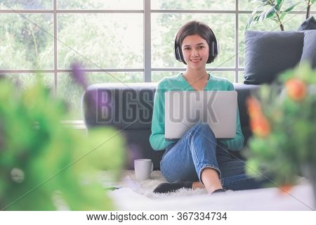 Young And Beautiful Cute Woman Half Race Thai-german Wearing Headphone And Using Laptop Notebook Com
