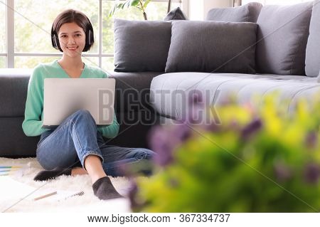 Young And Beautiful Cute Woman Half Race Thai-german Wearing Headphone And Using Laptop Notebook Com