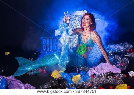Ocean Plastic Pollution Concept. Mermaid Lives To Polluted Habitat.
