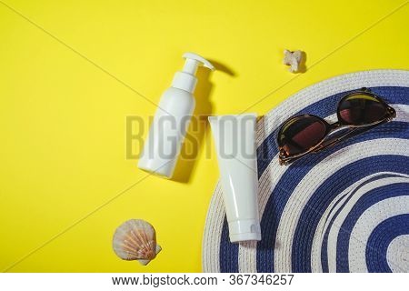 Sunprotection Objects. Straw Woman Hat With Sun Glasses And Protection Cream Spf On Yellow Backgroun