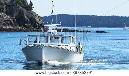 A Fishing Boat Returning From A Day Of Colecting Live Miane Lobsters To Bar Harbor Maine Usa.