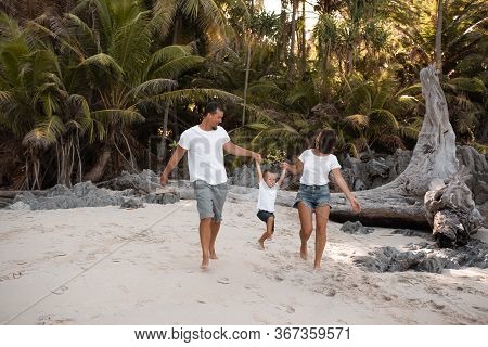 Happy Smile European Family Have Rest And Run On White Sand Beach. Father, Long Black Chestnut Hair 