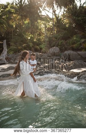Happy Smile European Family Have Rest And Run On White Sand Beach