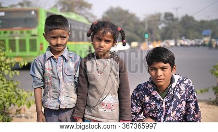Delhi, India - November 28, 2018: Portraits Of Children And Mothers Working And Begging On The Stree